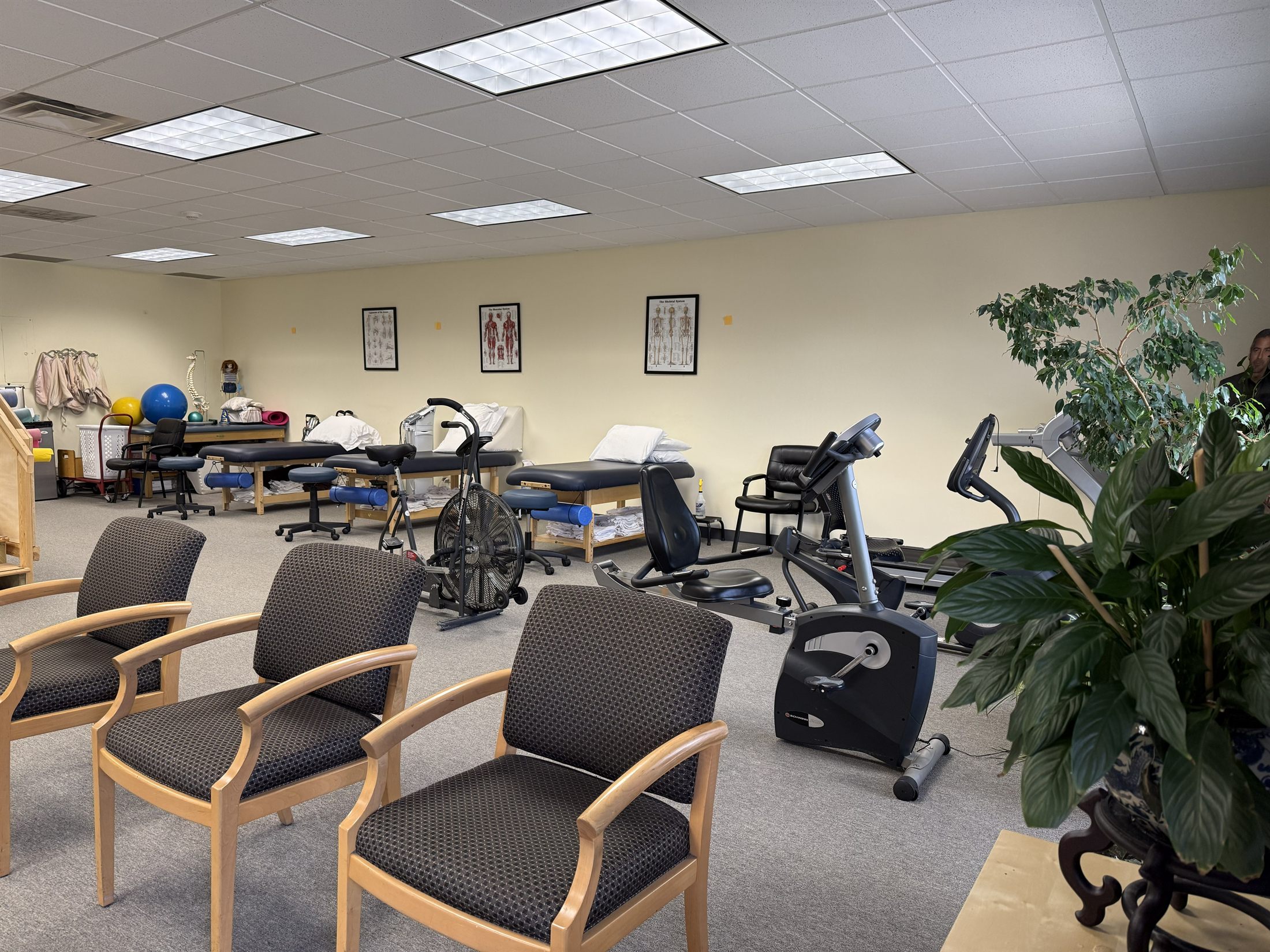 Treatment tables and exercise equipment inside Improved Functions Physical Therapy